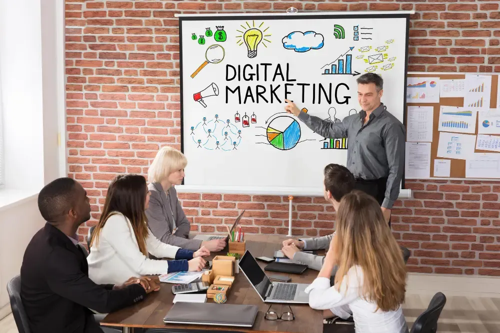 Digital marketing strategy session with team discussing on whiteboard