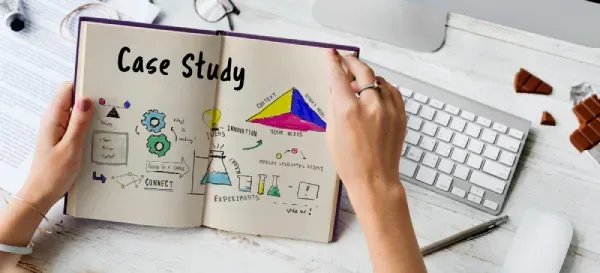 Creative professional sketching a case study plan in a notebook with ideas, experiments and research notes.
