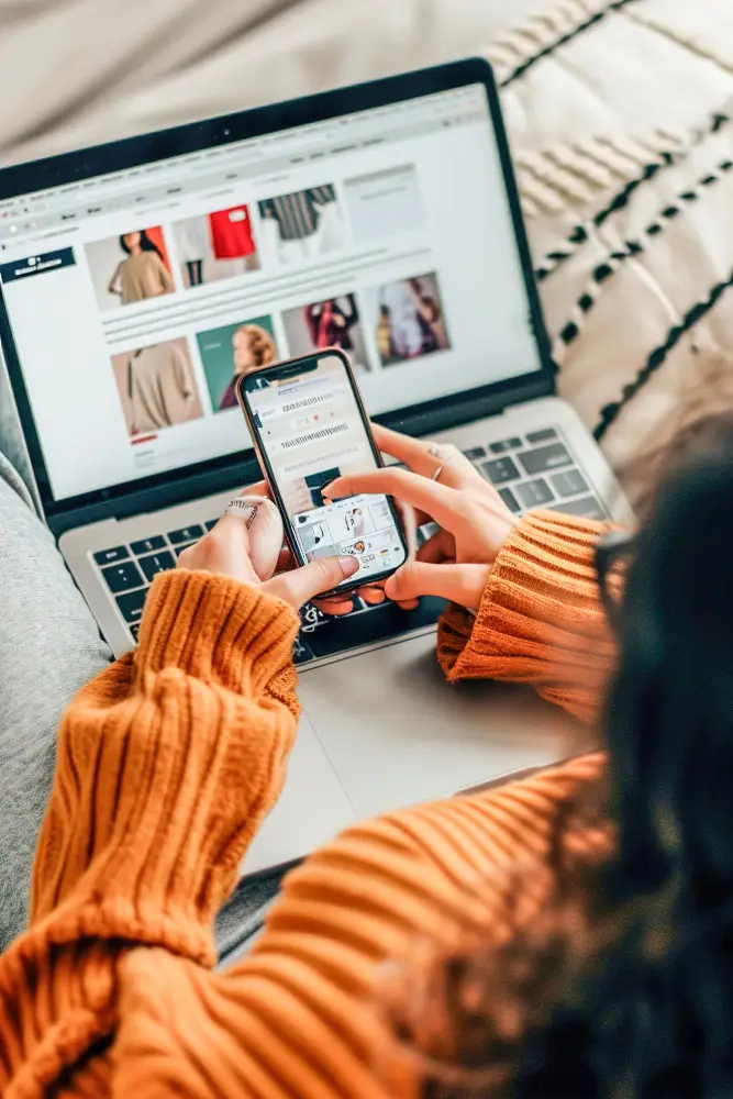 Person browsing and managing a Shopify store on laptop and mobile for a seamless ecommerce experience